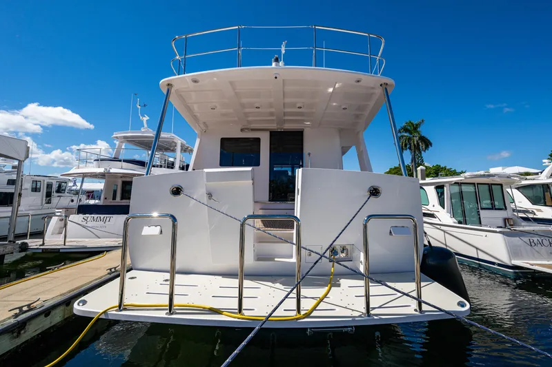 Slide: The Image of 2026 Kadey-Krogen 60 Open yacht docked at marina under clear blue sky. - 101