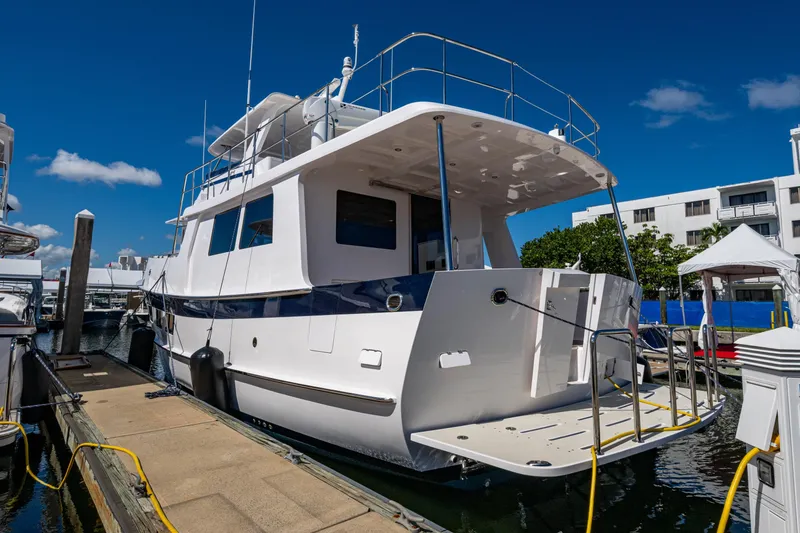 Slide: The Image of 2026 Kadey-Krogen 60 Open yacht docked at marina under clear blue sky. - 103