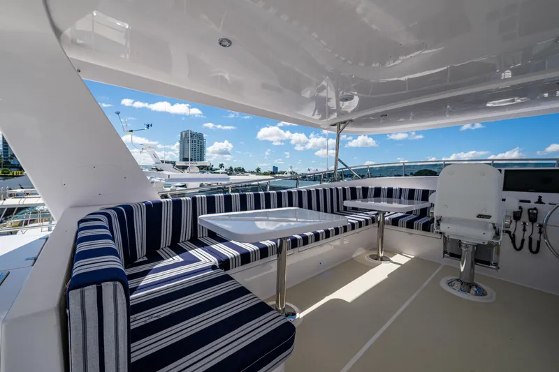 Slide: The Image of Luxurious 2026 Kadey-Krogen 60 Open yacht deck with striped seating and ocean view. - 91