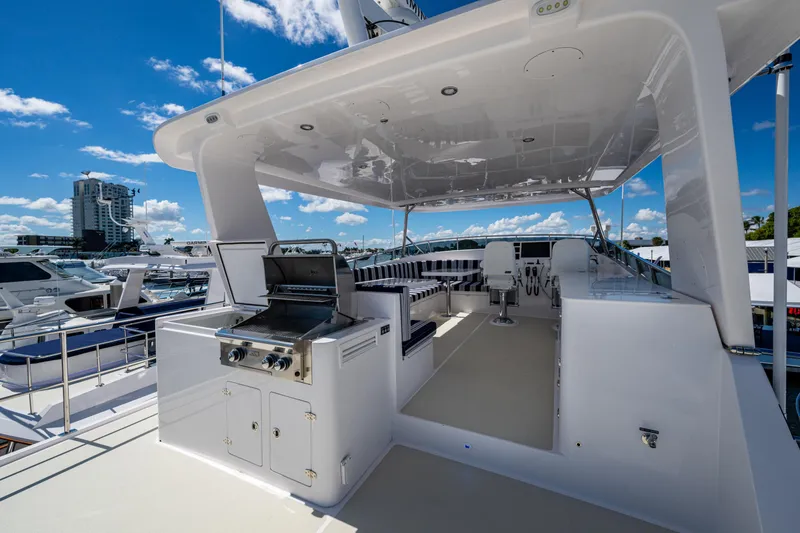 Slide: The Image of Luxurious 2026 Kadey-Krogen 60 Open yacht with outdoor grill and seating area. - 87
