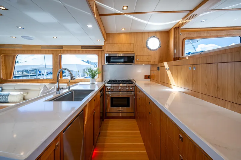 Slide: The Image of Luxurious 2026 Kadey-Krogen 60 Open yacht kitchen with modern appliances and elegant wood finish. - 8