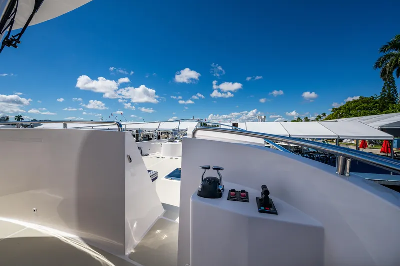 Slide: The Image of 2026 Kadey-Krogen 60 Open yacht deck with controls, under clear blue sky. - 78