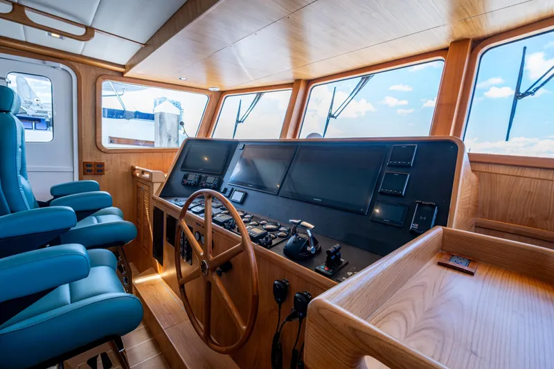 Slide: The Image of Pilothouse of 2026 Kadey-Krogen 60 Open yacht with modern navigation equipment and wooden interior. - 20