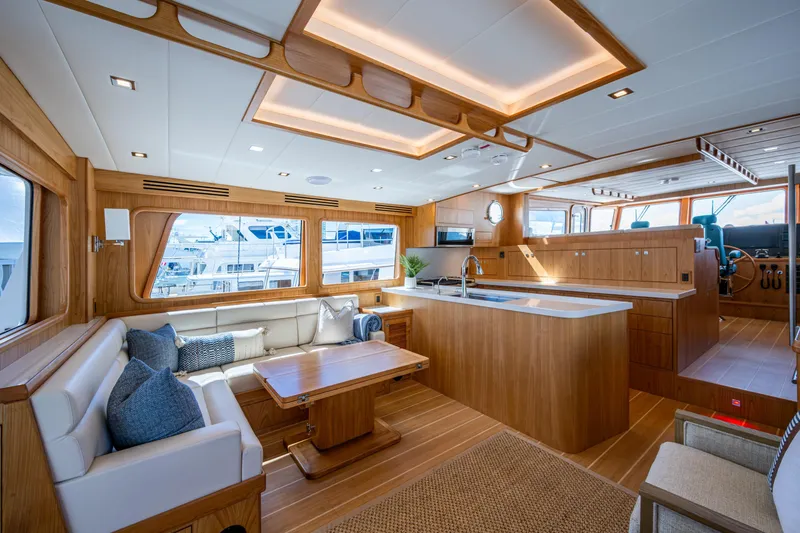 Slide: The Image of Luxurious interior of 2026 Kadey-Krogen 60 Open yacht with modern kitchen and seating area. - 2