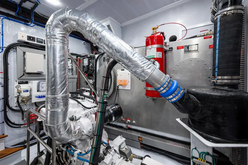 Slide: The Image of Engine room of 2026 Kadey-Krogen 60 Open yacht, featuring advanced machinery and fire safety equipment. - 64