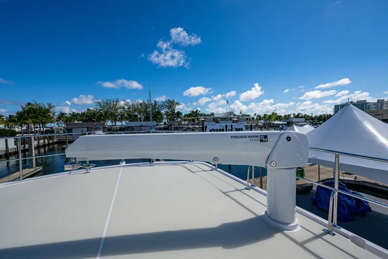 Slide: The Image of Kadey-Krogen 60 Open 2026 yacht deck with Steelhead Marine crane, sunny marina view. - 98