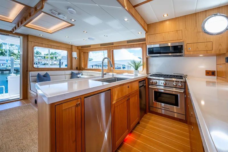 Slide: The Image of Luxurious Kadey-Krogen 60 Open yacht kitchen, 2026 model, featuring modern appliances and elegant wood finishes. - 9