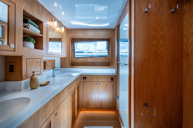 Slide: The Image of Luxurious Kadey-Krogen 60 Open 2026 yacht bathroom with wood cabinetry and modern fixtures. - 31
