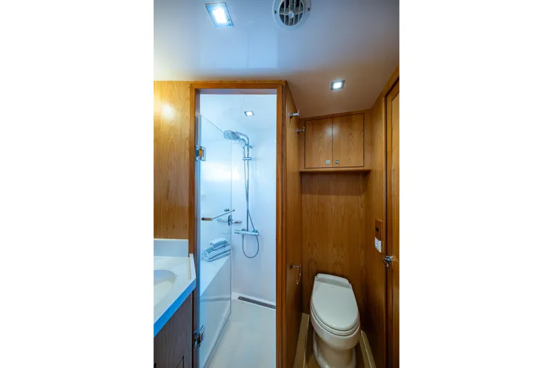 Slide: The Image of Modern bathroom in 2026 Kadey-Krogen 60 Open yacht, featuring wood paneling and shower. - 44