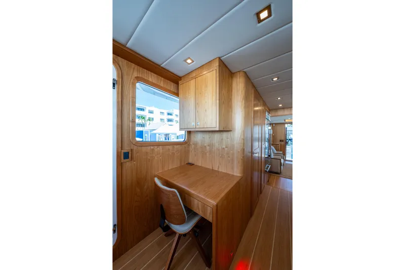 Slide: The Image of Interior of 2026 Kadey-Krogen 60 Open yacht with wooden desk and chair. - 24