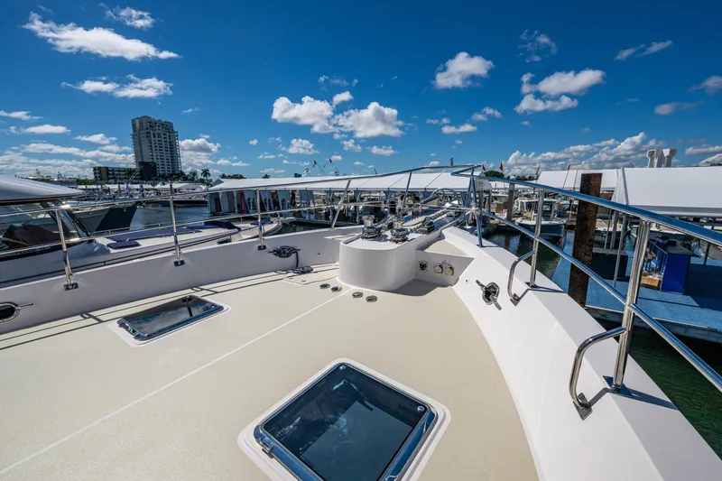 Slide: The Image of Kadey-Krogen 60 Open 2026 yacht deck with marina view under blue sky. - 79