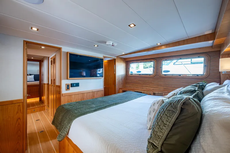 Slide: The Image of Luxurious 2026 Kadey-Krogen 60 Open yacht bedroom with elegant wood paneling and large windows. - 27