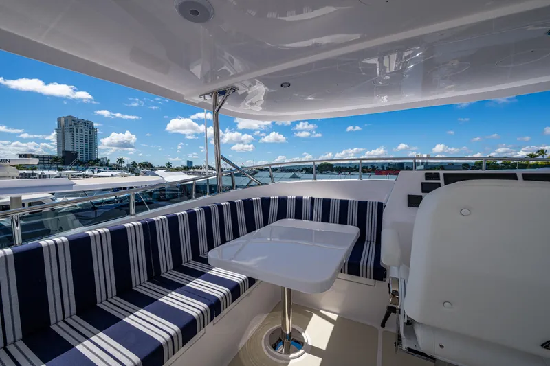 Slide: The Image of Luxurious 2026 Kadey-Krogen 60 Open yacht deck with striped seating and ocean view. - 94
