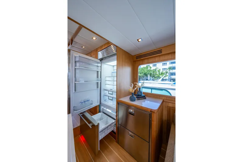 Slide: The Image of Luxurious 2026 Kadey-Krogen 60 Open yacht interior with modern kitchen and open refrigerator. - 13
