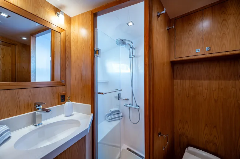 Slide: The Image of Luxurious 2026 Kadey-Krogen 60 Open yacht bathroom with wood paneling and modern fixtures. - 43