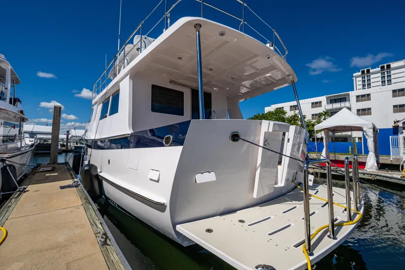 Slide: The Image of Luxury Kadey-Krogen 60 Open yacht docked, 2026 model, sunny marina setting. - 100