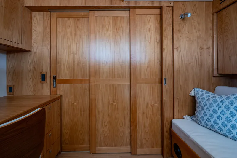 Slide: The Image of Interior of 2026 Kadey-Krogen 60 Open yacht with wooden sliding doors and cozy seating. - 54