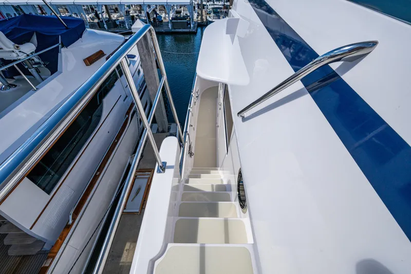 Slide: The Image of Stairway on 2026 Kadey-Krogen 60 Open yacht, featuring sleek design and polished railings. - 99