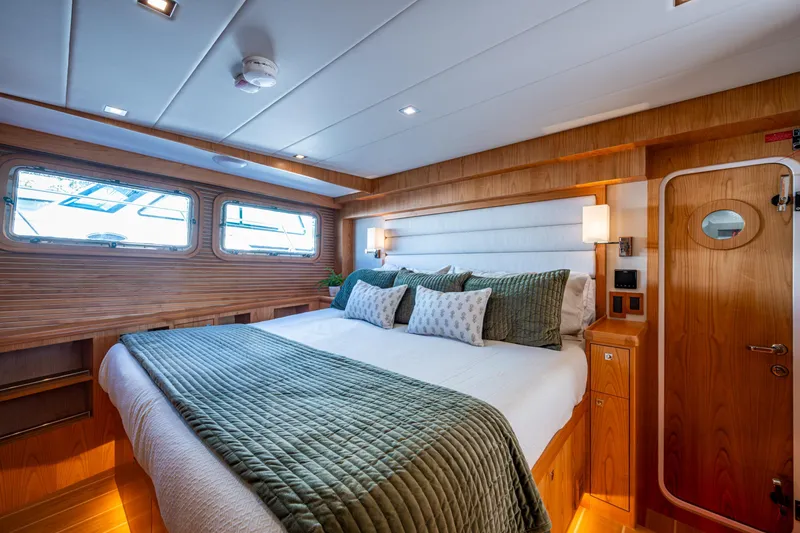 Slide: The Image of Luxurious 2026 Kadey-Krogen 60 Open yacht bedroom with elegant wood finish and plush bedding. - 25