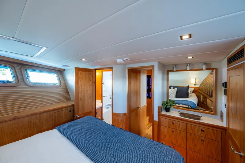 Slide: The Image of Luxurious 2026 Kadey-Krogen 60 Open yacht bedroom with elegant wood finishes and modern decor. - 39