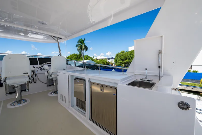 Slide: The Image of Luxurious 2026 Kadey-Krogen 60 Open yacht deck with helm, seating, and kitchenette. - 88