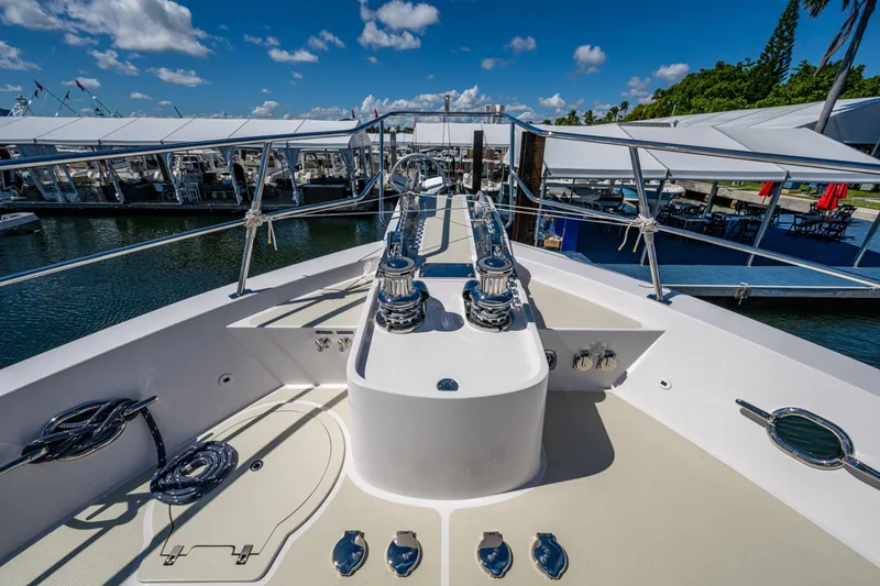 Slide: The Image of Bow view of 2026 Kadey-Krogen 60 Open yacht docked under clear skies. - 80