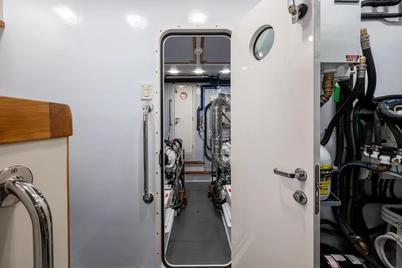 Slide: The Image of Engine room of 2026 Kadey-Krogen 60 Open yacht, featuring modern equipment and piping. - 72