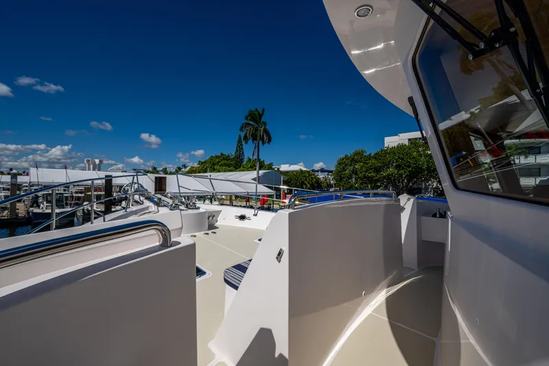 Slide: The Image of 2026 Kadey-Krogen 60 Open yacht deck with clear blue sky and marina view. - 84