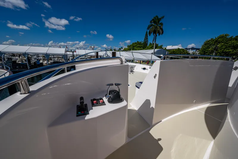 Slide: The Image of 2026 Kadey-Krogen 60 Open yacht deck with controls, marina view, and clear blue sky. - 83
