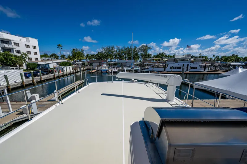 Slide: The Image of Rooftop view of 2026 Kadey-Krogen 60 Open yacht docked at marina under clear blue sky. - 97
