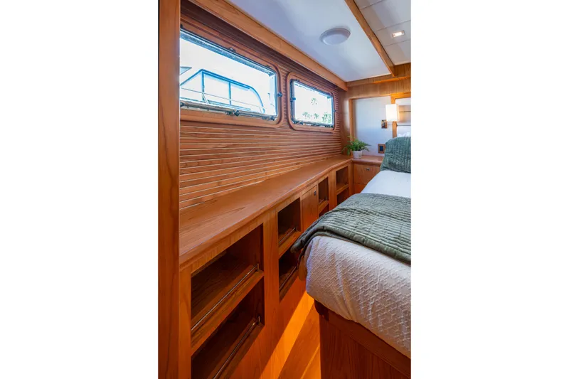 Slide: The Image of Luxurious interior of 2026 Kadey-Krogen 60 Open yacht with wooden cabinetry and cozy bedding. - 29