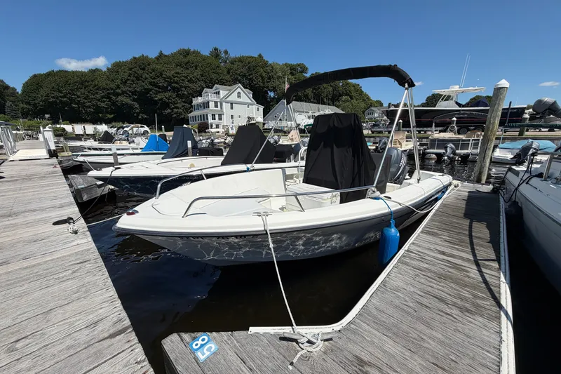 Slide: The Image of 2003 Hydra-Sports 180 CC boat docked at a marina under clear blue skies. - 2
