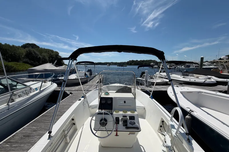 Slide: The Image of 2003 Hydra-Sports 180 CC boat docked at marina under clear blue sky. - 14