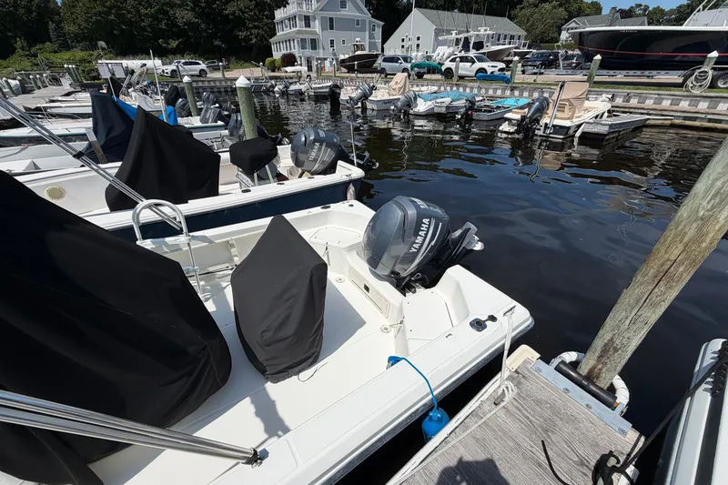 Slide: The Image of 2003 Hydra-Sports 180 CC boat docked with Yamaha outboard motor, marina background. - 4