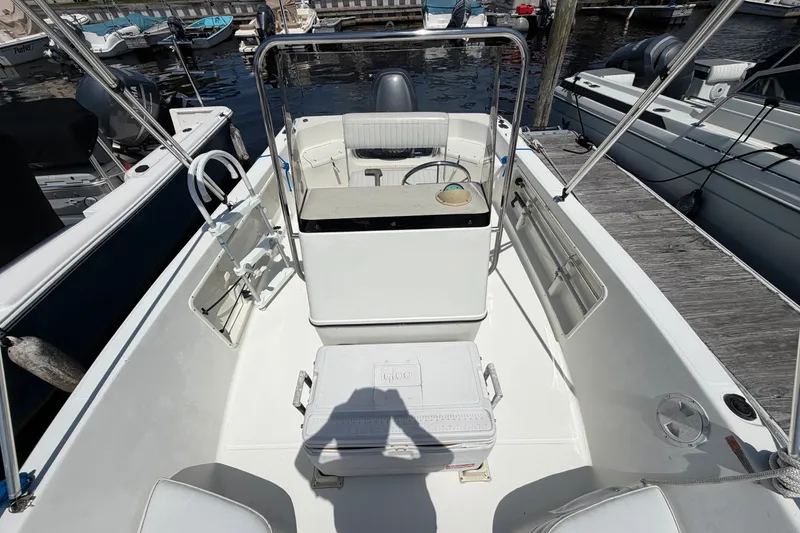 Slide: The Image of 2003 Hydra-Sports 180 CC boat interior at dock, featuring seating and steering console. - 9