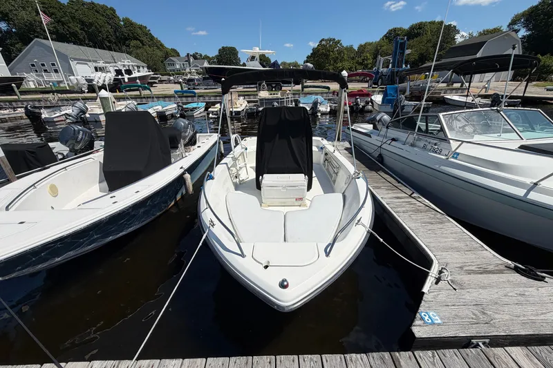 Slide: The Image of 2003 Hydra-Sports 180 CC boat docked at a marina, surrounded by other vessels. - 1