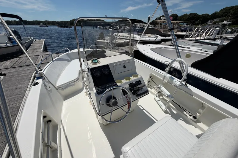 Slide: The Image of 2003 Hydra-Sports 180 CC boat interior at dock, featuring steering console and seating. - 10