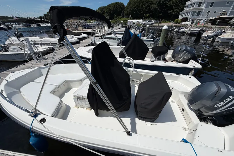 Slide: The Image of 2003 Hydra-Sports 180 CC boat docked, featuring Yamaha outboard motor, covered seats, and marina backdrop. - 3