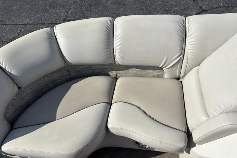 Slide: The Image of Cream leather seating on a 2015 Manitou 25 SHP SES boat. - 19
