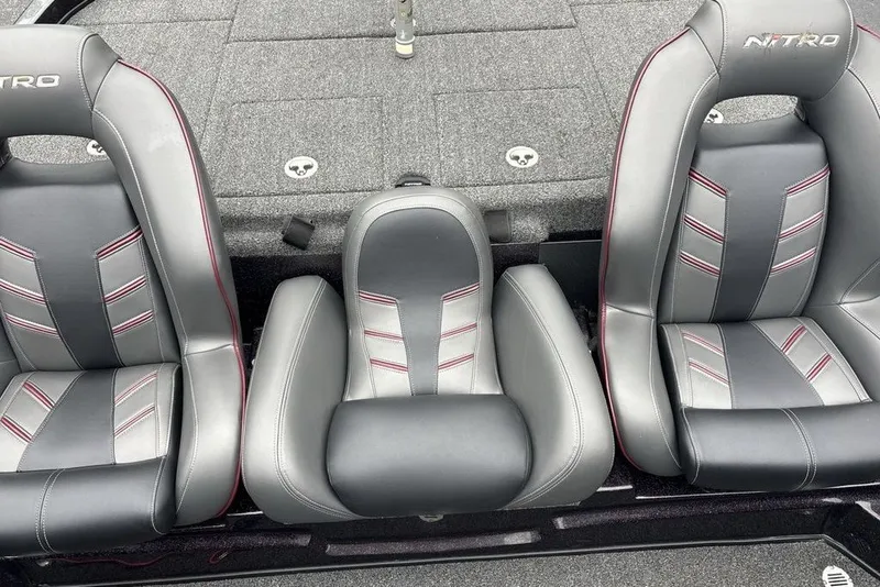 Slide: The Image of 2021 Nitro Z21 boat seats with gray and black upholstery, featuring red stitching. - 28