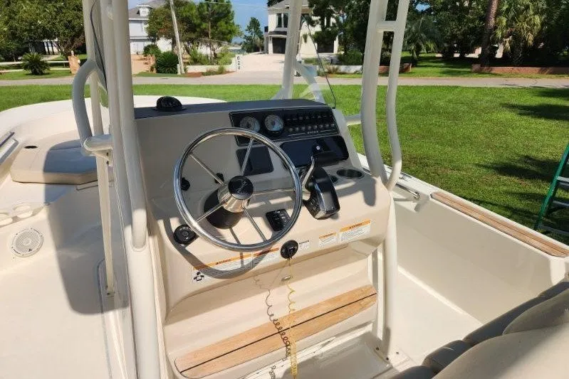Slide: The Image of 2023 Boston Whaler 210 Montauk boat dashboard with steering wheel and controls. - 4