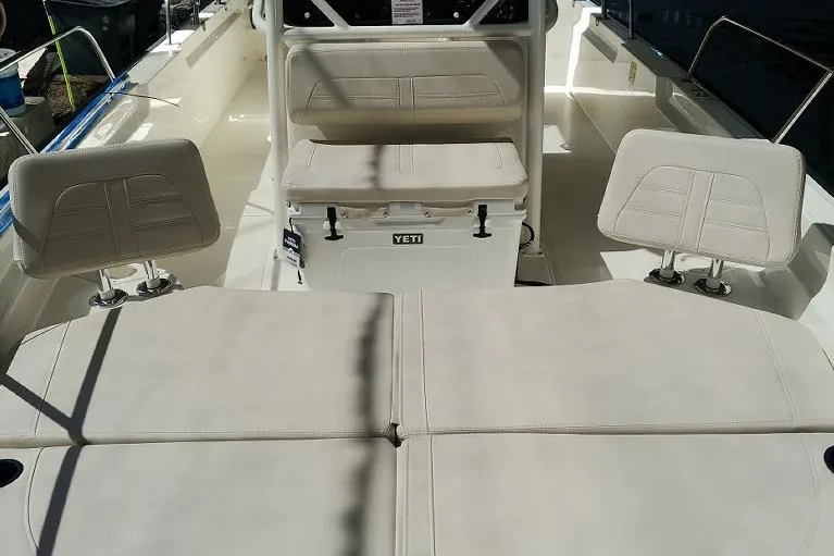 Slide: The Image of Manufacturer Provided Image: 2023 Boston Whaler 210 Montauk boat interior with cushioned seating and Yeti cooler. - 18
