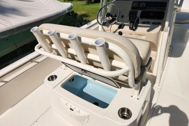 Slide: The Image of 2023 Boston Whaler 210 Montauk boat interior with rod holders and steering console. - 3