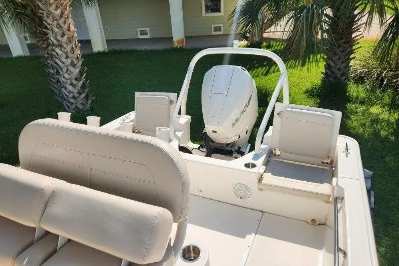 Slide: The Image of 2023 Boston Whaler 210 Montauk boat interior with seating and outboard motor. - 7