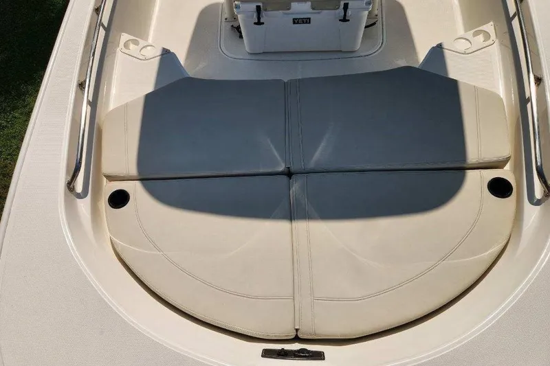 Slide: The Image of 2023 Boston Whaler 210 Montauk boat deck with cushioned seating and cup holders. - 8