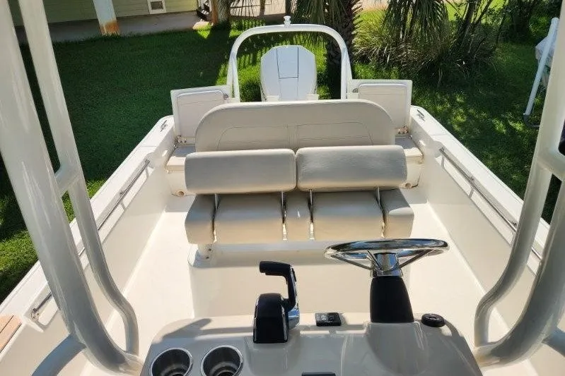 Slide: The Image of 2023 Boston Whaler 210 Montauk boat interior with seating and steering wheel. - 6
