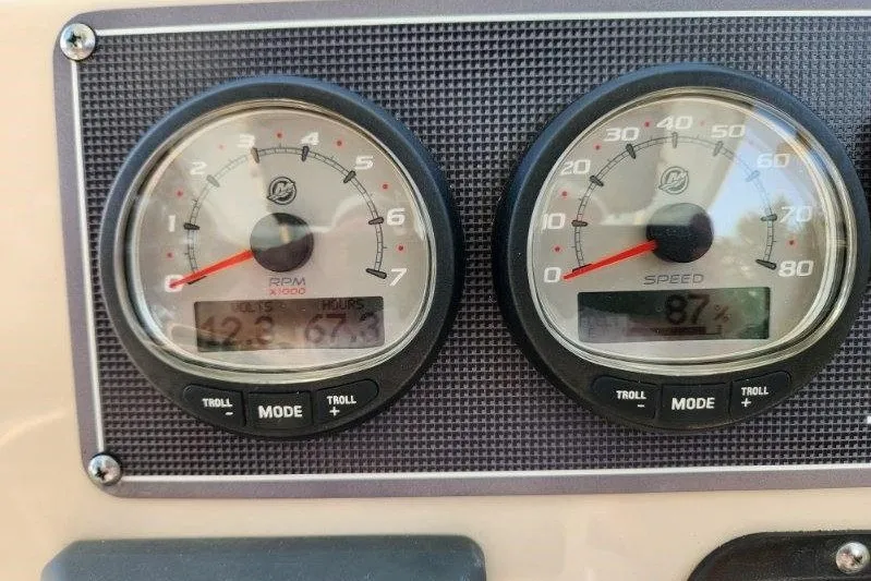 Slide: The Image of Dashboard gauges of a 2023 Boston Whaler 210 Montauk boat, displaying RPM and speed. - 5