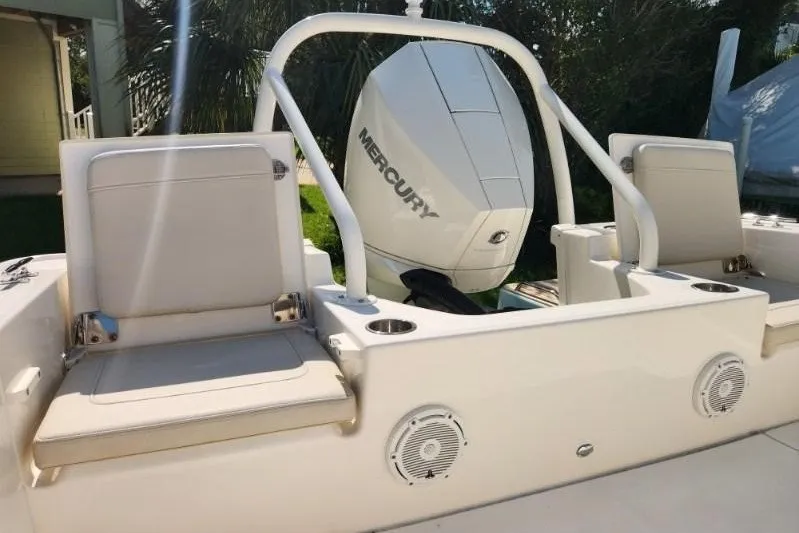Slide: The Image of 2023 Boston Whaler 210 Montauk boat with Mercury engine and seating area. - 9