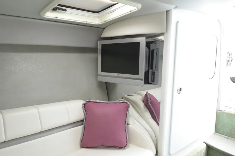 Slide: The Image of Interior of 2006 Formula 353 FASTech boat with TV, white seating, and purple pillows. - 18