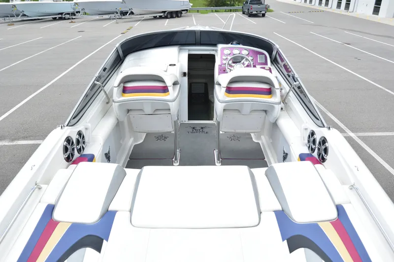 Slide: The Image of 2006 Formula 353 FASTech boat interior with colorful seating and modern dashboard in a parking lot. - 15